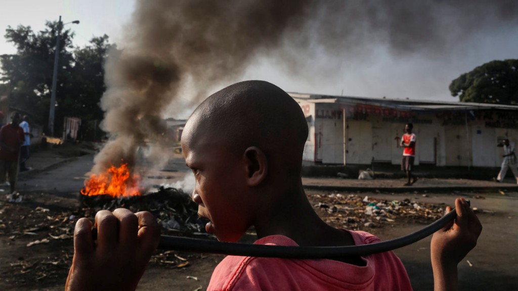A Burundian boy looks on as he holds a stick in front of a burning barricade during an anti-government demonstration against President Pierre Nkurunziza's bid for a third term in Cibitoke neighborhood of Bujumbura, Burundi, 29 May 2015. The Burundi crisis started after an announcement from the President Pierre Nkurunziza that he intended to run for a third term mandated in the upcoming elections. The statement sparked various protests in all over country, generating clashes from the government supporters and opposers. EPA/DAI KUROKAWA